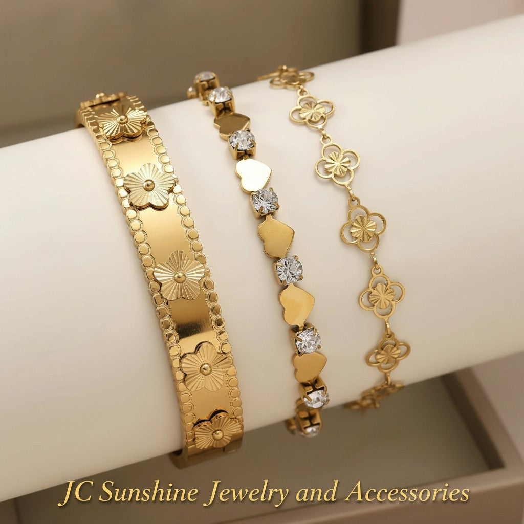 JC Sunshine Jewelry and Accessories gold-plated stainless steel cuff bracelet with flower motifs and cubic zirconia accents.